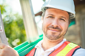 inspector or engineer with ladder checking the building structure and house roof specifications.