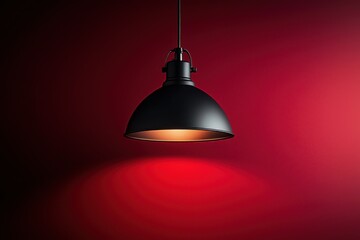 Obraz premium Stylish black pendant lamp illuminating a red wall