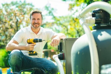 Electrician working on heat pump close to a pool