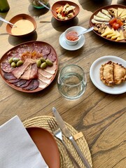 Brunch scene on a wooden surface in Alfa Crux wines, Valle de Uco. Argentina.