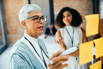 Senior businesswoman facilitating a creative strategy session with colleague