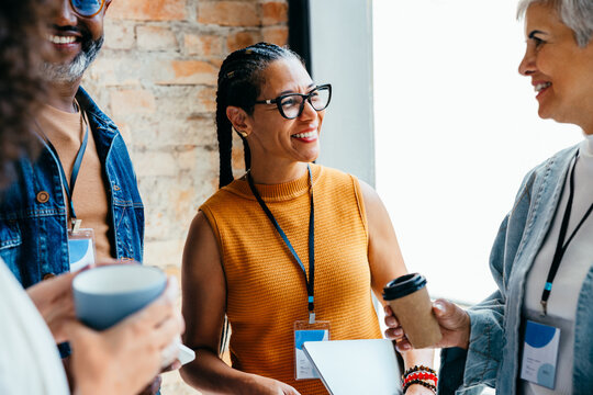 Group of business professionals enjoying a casual conversation with coffee