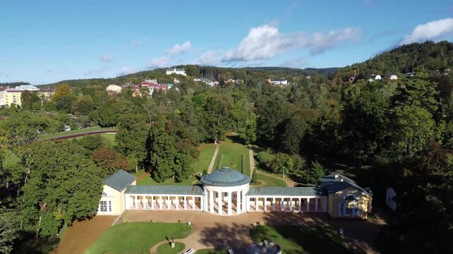 Czech spa town Marianske Lazne (Marienbad) - drone flight through the spa park from the pavilion of Rudolf Spring to the small colonnade of Ferdinand Spring