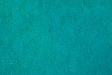 A vibrant teal textured background with a grunge effect. Ideal for use in graphic design, presentations, or as a creative backdrop for various projects, offering a bold and abstract visual element.