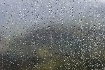 raindrops on window glass close-up, background