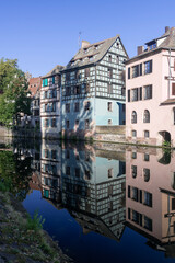 Strasbourg, France - August 28th 2024 : View of the Tanner's Quarter with half-timbered buildings and the Ill river and reflections on the water.