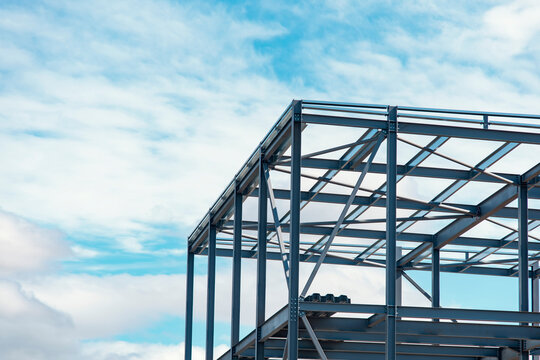 Steel Framework Rises Against Vibrant Sky During Construction at Bustling Urban Site