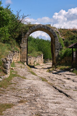 ancient stone archway leading to a historic pathway