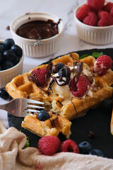still life Belgian waffles on a black round plate