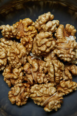 Close-up of Organic Walnut Kernels in a Bowl. Healthy eating and vegan concept. 