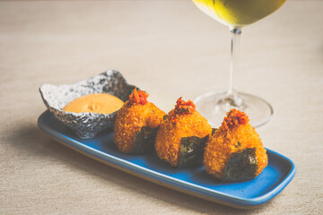 Kimchi Onigiri Arancini Fried breaded rice dumplings, kimchi slaw, gorgonzola cheese.