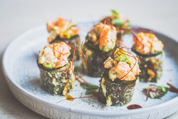 Deep fried mixed seafood maki roll, raw seafood medley, homemade sriracha sweet soy