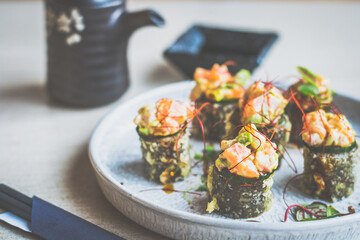 Deep fried mixed seafood maki roll, raw seafood medley, homemade sriracha sweet soy