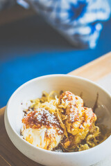 Tempura Banana.Batter fried banana, black sugar, gula melaka, coconut ice cream, sago.