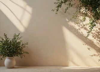 A white vase with a plant in it sits on a table in front of a wall