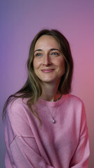 Fototapeta premium Woman Smiling in Pink Sweater Against Purple Gradient Background