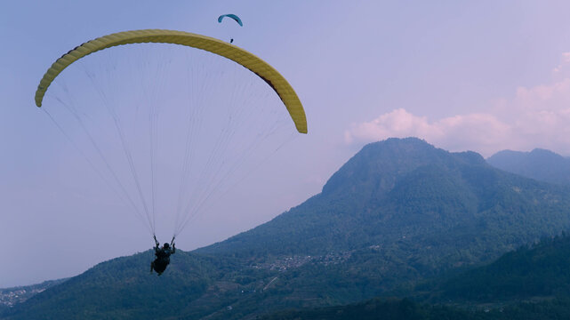 Skydiving from Paralayang Gunung Banyak Hills, Batu, Malang, East Java. Paragliding over the beautiful view.
