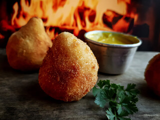  fried coxinha typical Brazilian food snack with sauce
