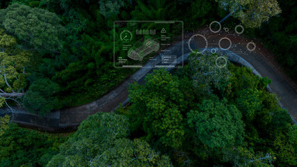 Aerial top view road in forest with car motion blur. Winding road through the forest. Car drive on the road between green forest. Ecosystem ecology healthy environment road trip.