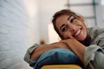 Young woman day dreaming while relaxing at home.