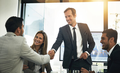 Smile, business people and shaking hands in meeting for deal, b2b partnership or investment agreement. Happy group, collaboration or handshake for acquisition, success or financial support in office