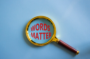 Words Matter symbol. Magnifying Glass with Concept word Words Matter. Beautiful blue background....
