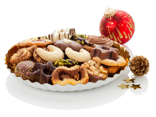 Assortment of Christmas cookies on plate with decoration on white background