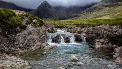 Beautiful waterfalls at the Fairy Pools, the waterfalls that flow from the River Brittle, with the Black Cuilins mountains on the Isle of Skye in the background.