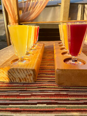 Multicolored transparent cocktails, a set of shots in one row