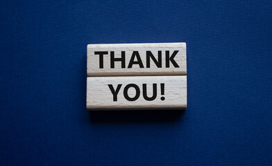 Thank you symbol. Wooden blocks with words Thank you. Beautiful deep blue background. Business and Thank you concept. Copy space.