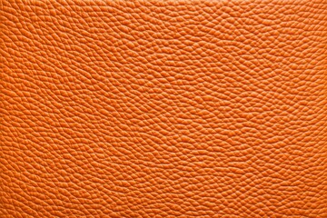 This image displays a close-up view of orange leather material with a detailed texture, showcasing...