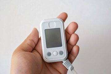 Doctor is holding a portable pulse oximeter, a medical device used to measure blood oxygen saturation and pulse rate