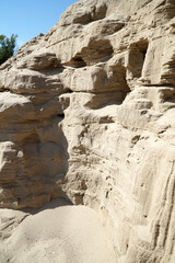 Majestic sand dunes. Mountains of sand, in which nests of birds are visible.
