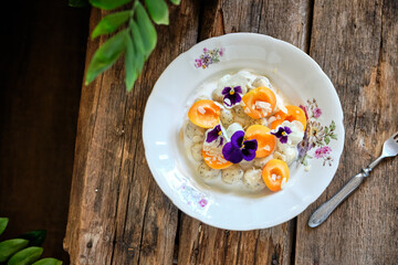 lazy dumplings with apricots, cream and edible flowers