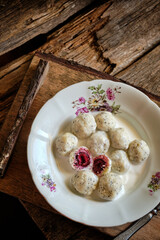 lazy dumplings with poppy seeds and cherry filling with cream sauce