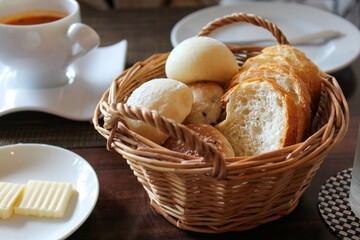 Assorted bread rolls served in wicker basket on restaurant table