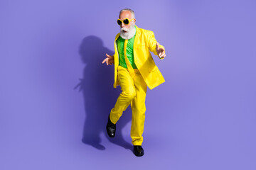 Photo of optimistic positive senior man wearing stylish yellow clothes celebrate event isolated on...