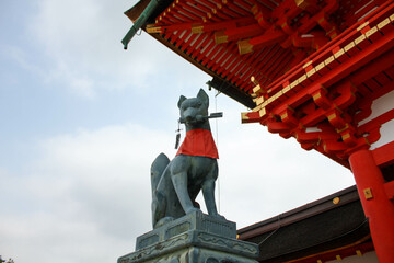 Bronze kitsune fox statue at Fushimi Inari Taisha shrine gate in Kyoto
