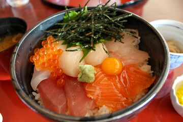 Japanese seafood rice bowl with salmon tuna and scallops