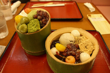 Bamboo cups filled with japanese matcha ice cream and red bean sweets