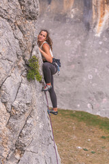 A strong woman rock climbing
