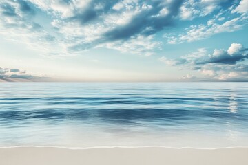 Obraz premium Serene Coastal Dawn: Tranquil ocean waves gently caress the sandy shore under a breathtaking sunrise sky, evoking feelings of peace and serenity.