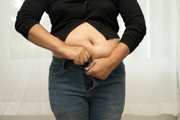 Asian woman show fat belly big size overweight and obesity isolated on white background with...