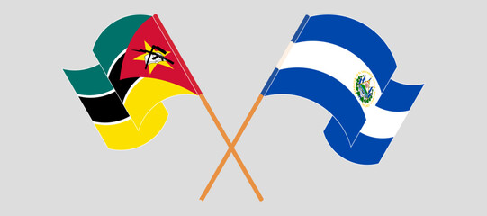 Crossed and waving flags of Mozambique and Republic of El Salvador. Vector illustration