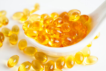 Fish oil capsules omega 3 vitamin with EPA and DHAvon white background.