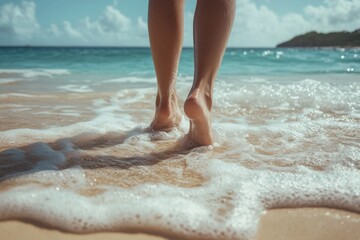 Legs of a young woman walking on the beach, close up