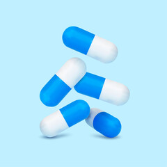 Falling blue white medicine pills capsules on white background.