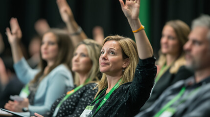 Fototapeta premium People at a conference, raising their hand to ask a question during a discussion.