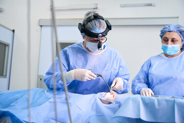 Surgeon performs a polypotomy on a young patient
