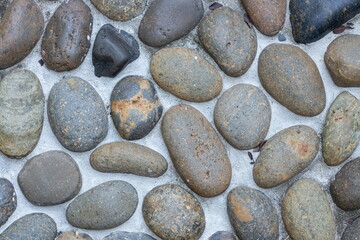 Close-up of a pebble-patterned walkway surface.